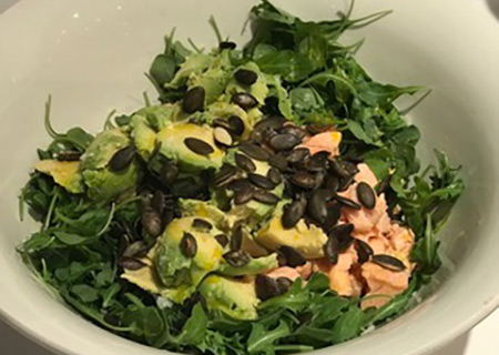 Salmon, avocado, watercress and pumpkin seed salad